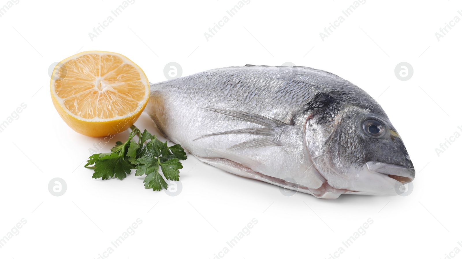 Photo of Raw dorado fish, lemon and parsley isolated on white