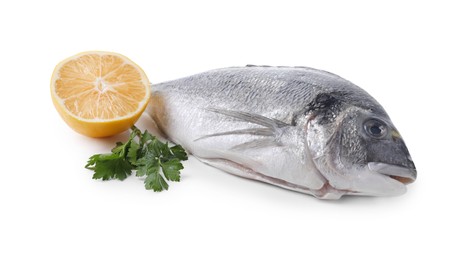 Raw dorado fish, lemon and parsley isolated on white