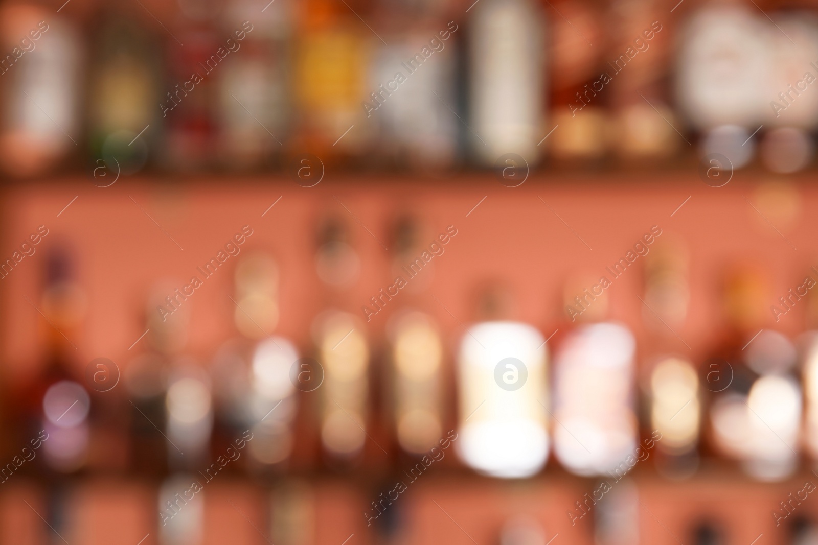 Photo of Blurred view of shelves with alcohol drinks in bar