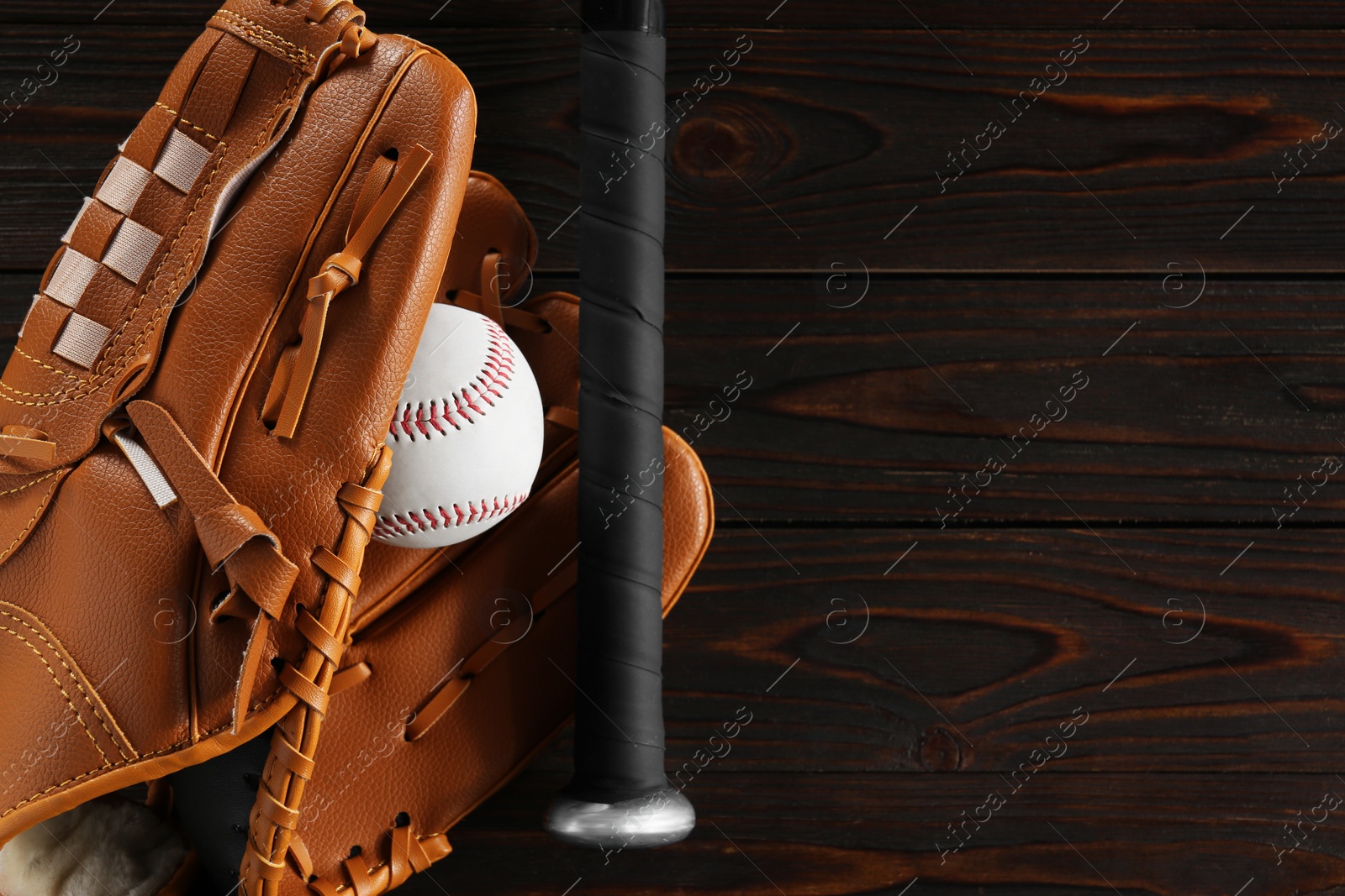 Photo of Baseball glove, bat and ball on wooden table, flat lay. Space for text