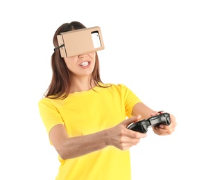 Photo of Young woman using cardboard virtual reality headset, isolated on white