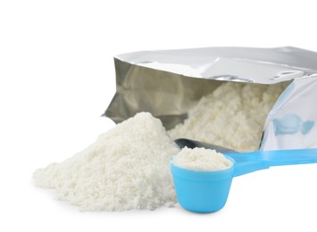 Photo of Bag of powdered infant formula and scoop on white background. Baby milk