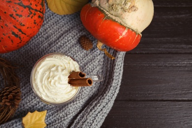 Flat lay composition with tasty pumpkin spice latte on table. Space for text