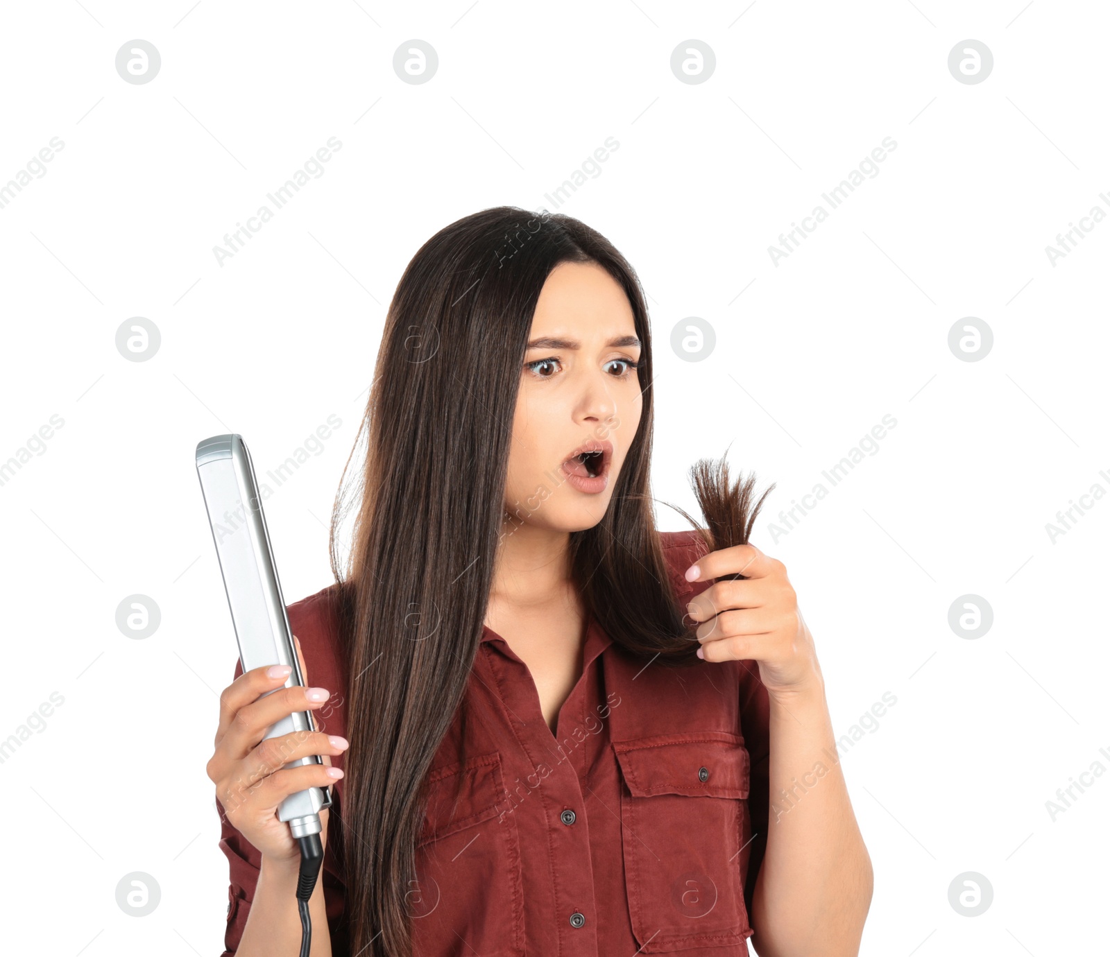 Photo of Upset woman with hair iron on white background