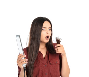 Upset woman with hair iron on white background