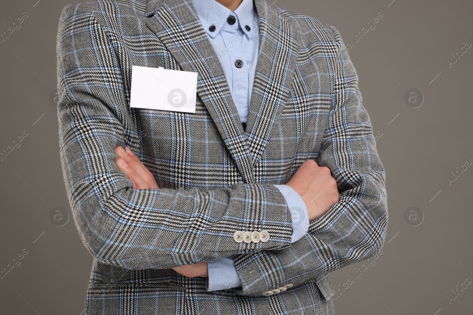 Photo of Man with blank badge on grey background, closeup