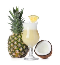 Tasty Pina Colada cocktail and ingredients on white background