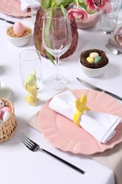 Festive table setting with napkin ring in shape of bunny ears. Easter celebration