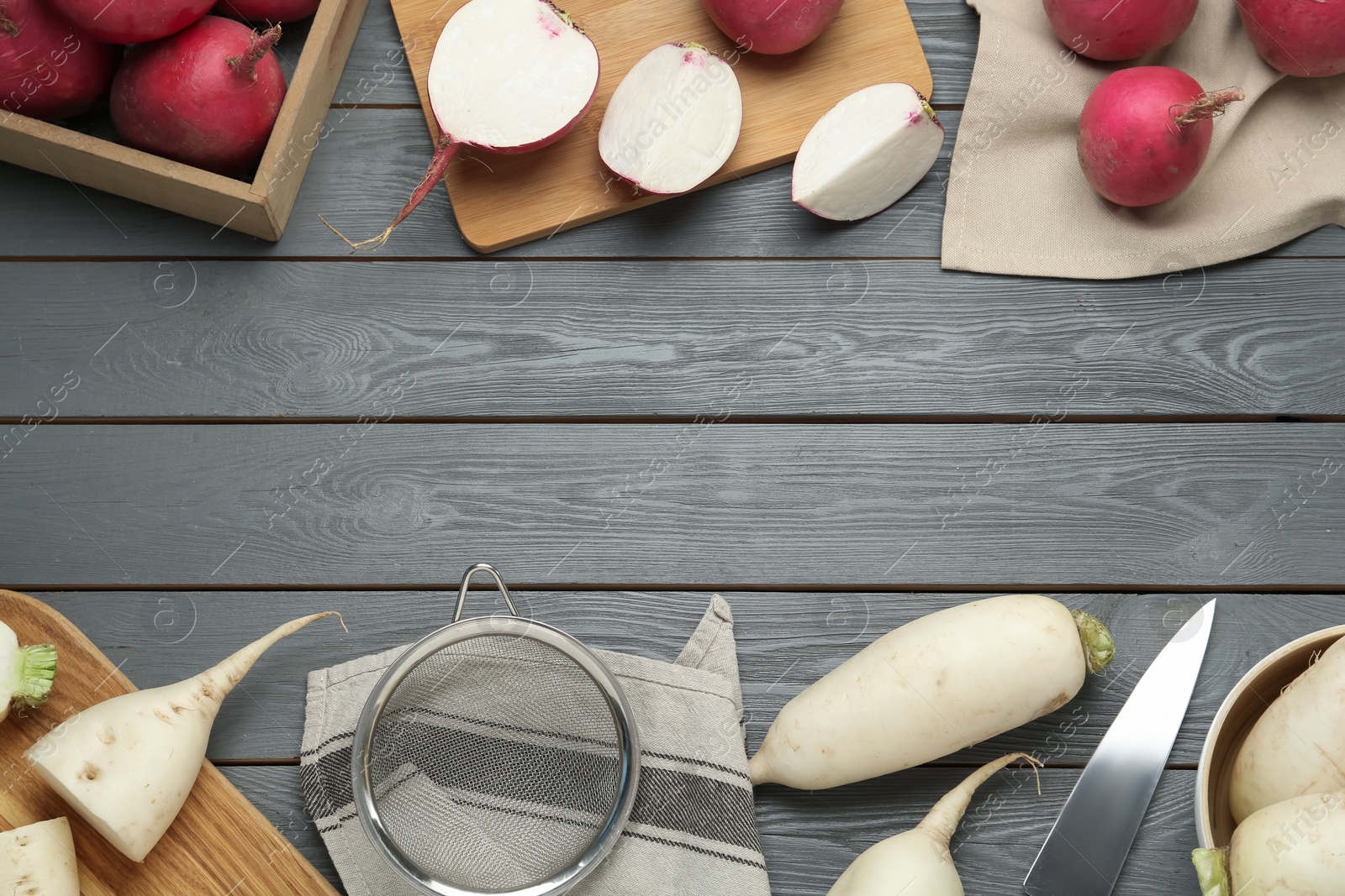 Photo of Raw turnips on grey wooden table, flat lay. Space for text