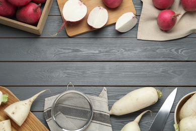 Raw turnips on grey wooden table, flat lay. Space for text