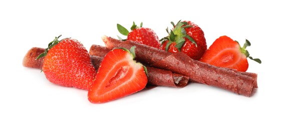 Photo of Delicious fruit leather rolls and strawberries on white background