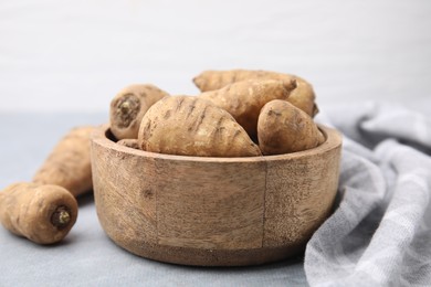 Tubers of turnip rooted chervil on light grey table, closeup