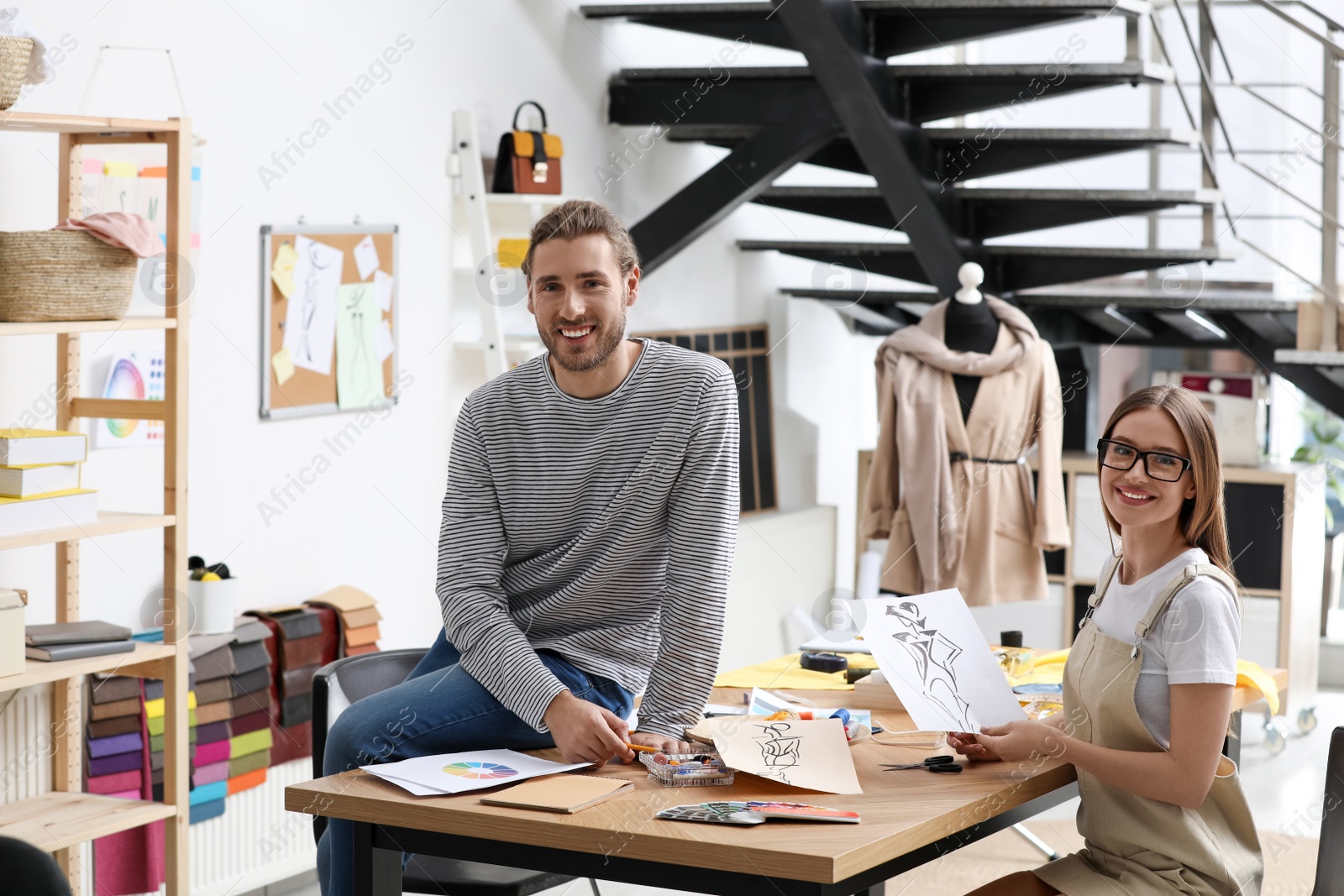 Photo of Fashion designers creating new clothes in studio