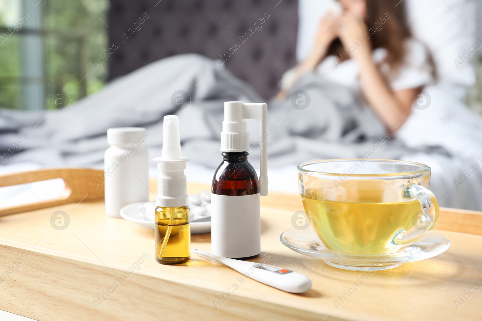 Photo of Cold remedies and sick woman on background indoors