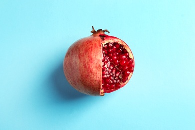 Photo of Ripe pomegranate on color background, top view