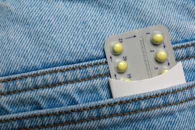 Photo of Birth control pills in pocket of jeans, closeup
