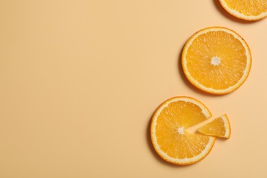 Slices of juicy orange on beige background, flat lay. Space for text