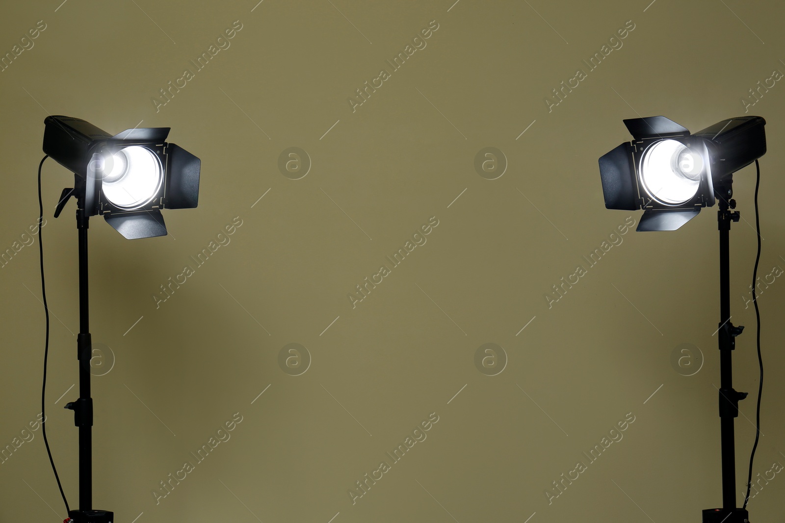 Photo of Modern spotlights against beige background, space for text