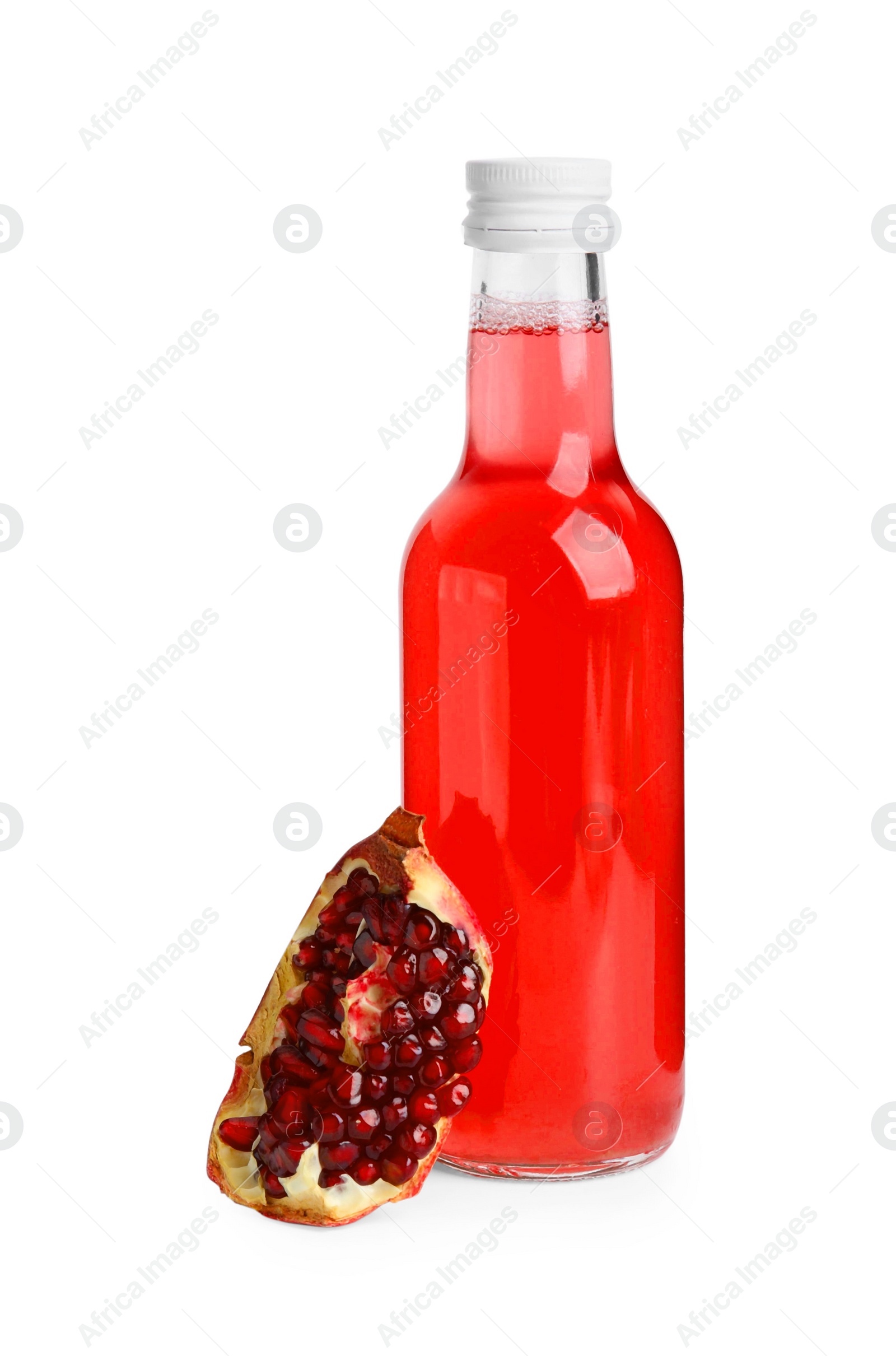 Photo of Delicious kombucha in glass bottle and pomegranate isolated on white