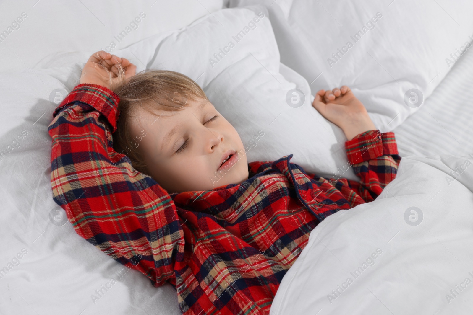 Photo of Little boy snoring while sleeping in bed