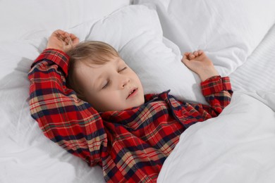 Little boy snoring while sleeping in bed