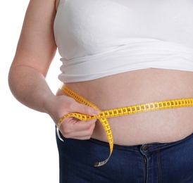 Overweight woman measuring waist with tape isolated on white, closeup