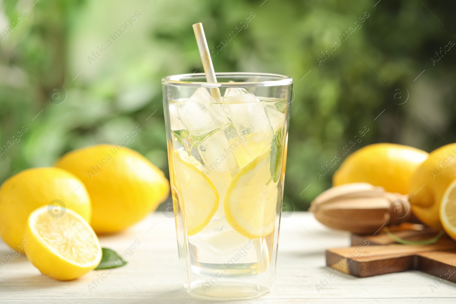 Photo of Cool freshly made lemonade and fruits on white wooden table, closeup