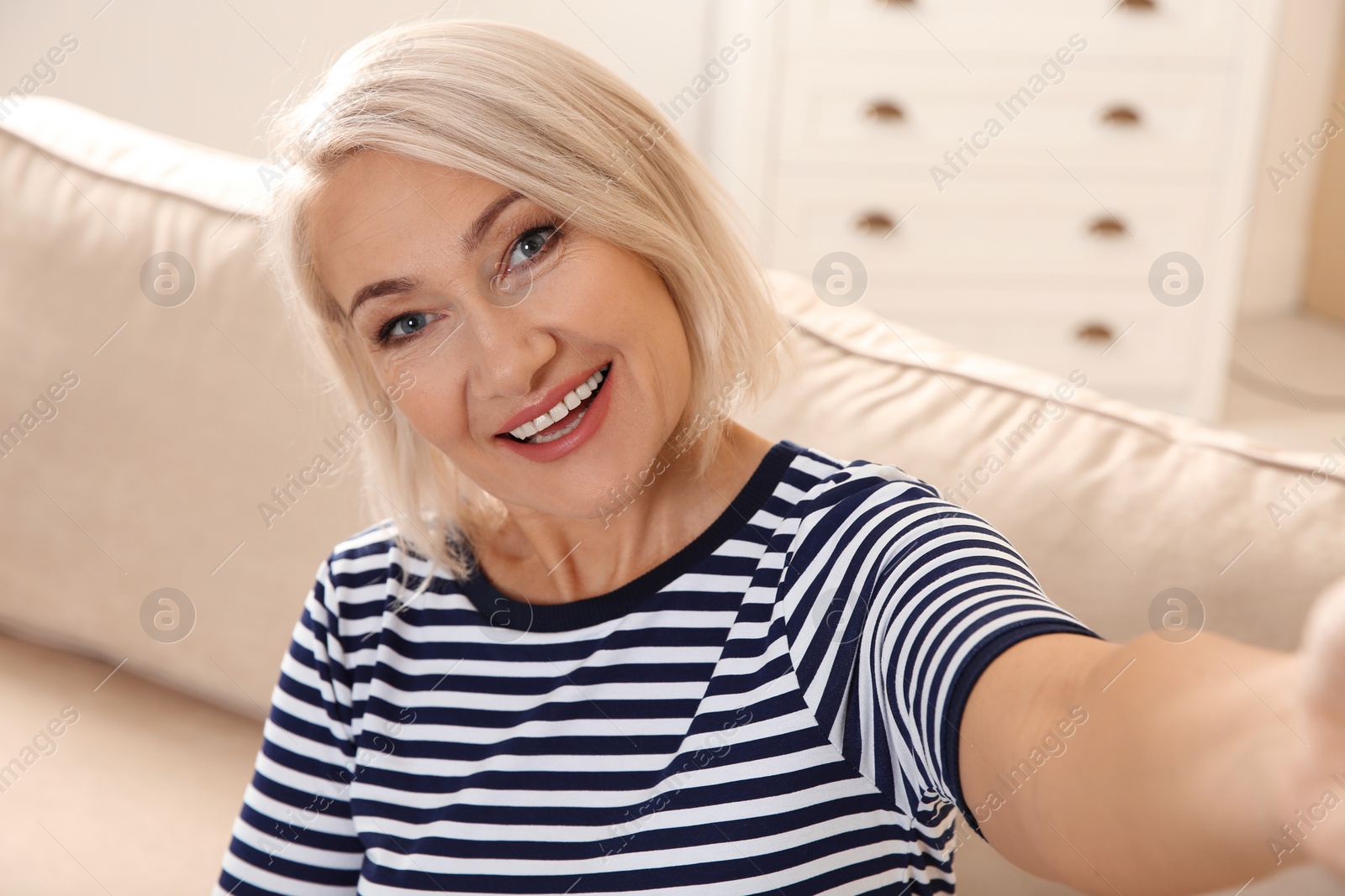 Photo of Mature woman using video chat at home, view from web camera