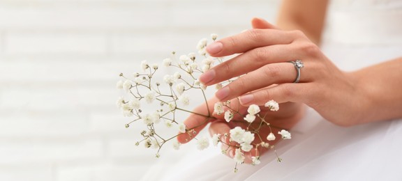 Image of Young bride wearing beautiful engagement ring, closeup view with space for text. Banner design