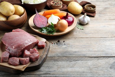 Photo of Fresh ingredients for borscht on wooden table