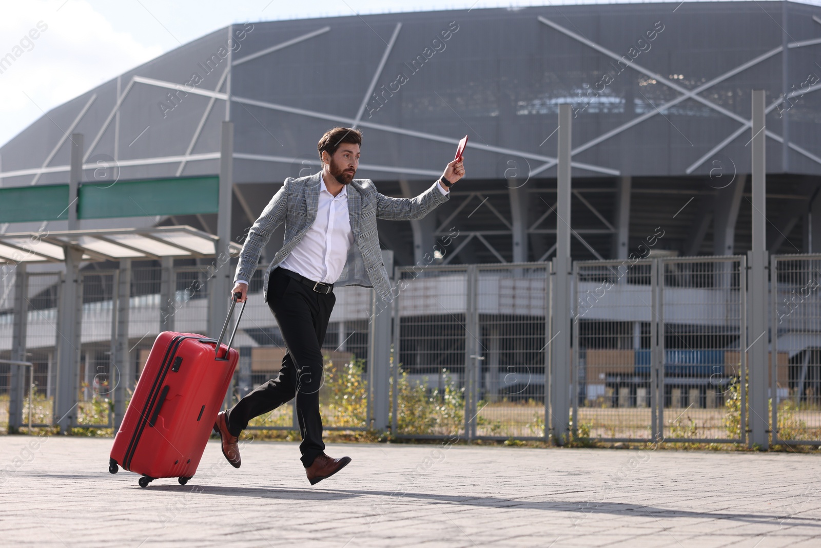 Photo of Being late. Businessman with red suitcase and passport running outdoors, space for text