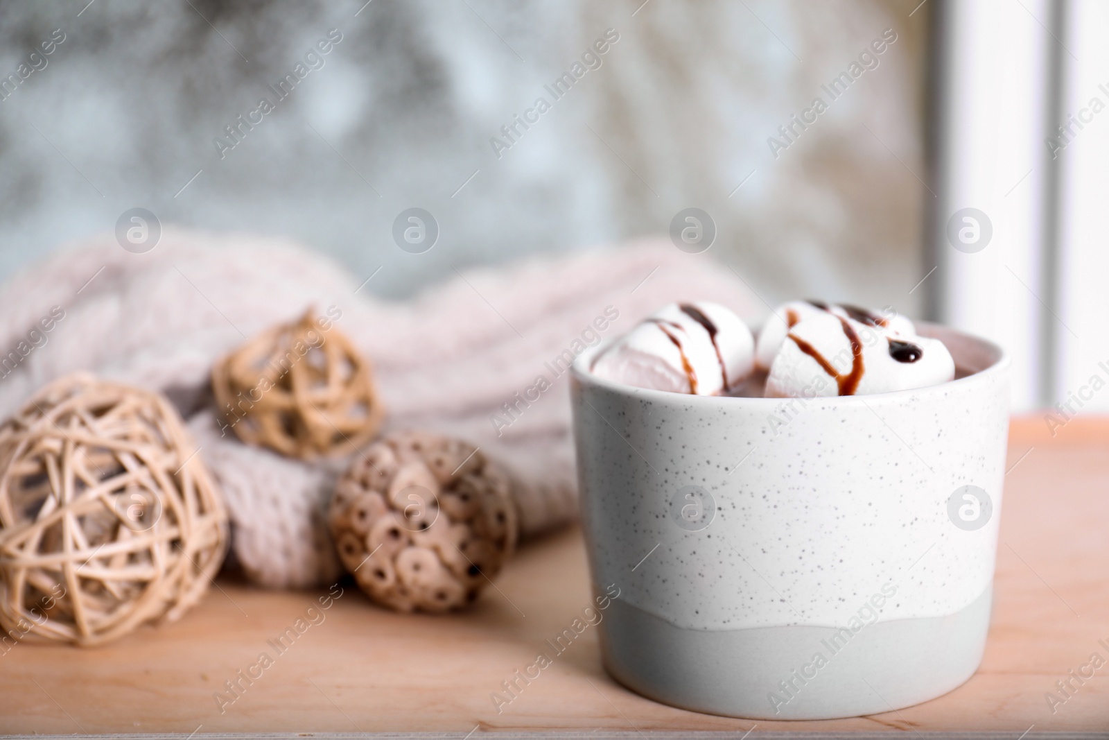 Photo of Cup of aromatic cacao with marshmallows on wooden table