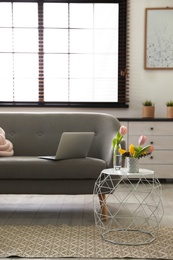 Photo of Interior of cozy living room with grey sofa