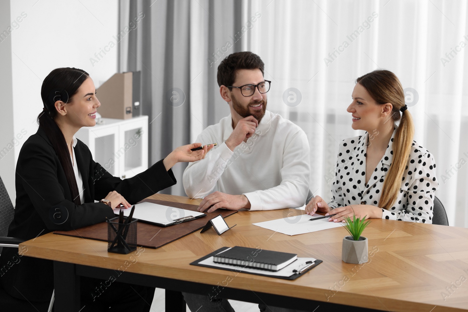 Photo of Couple having meeting with lawyer in office