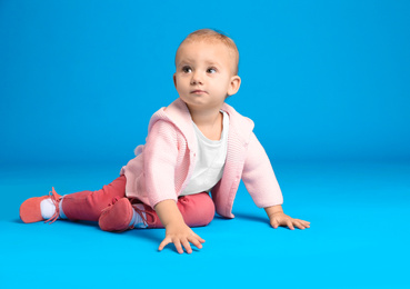 Photo of Cute little child on light blue background