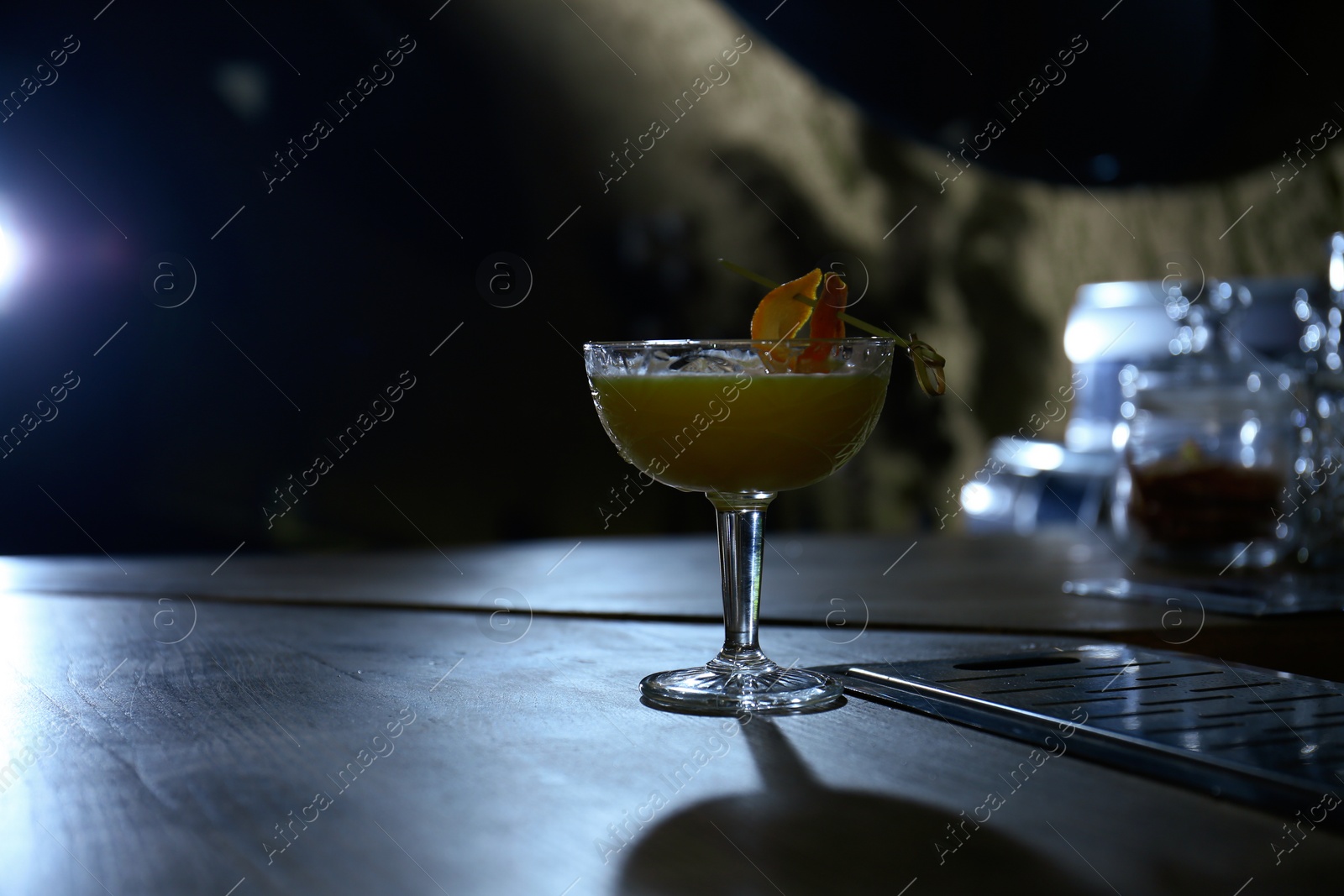 Photo of Glass of fresh alcoholic cocktail on bar counter