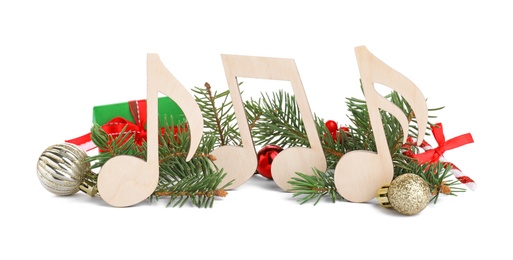 Wooden music notes with fir tree branches and Christmas decor on white background