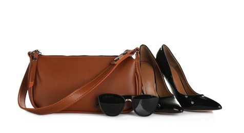 Photo of Brown women's mini bag, shoes and sunglasses on white background