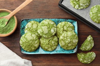 Photo of Tasty matcha cookies and powder on wooden table, flat lay