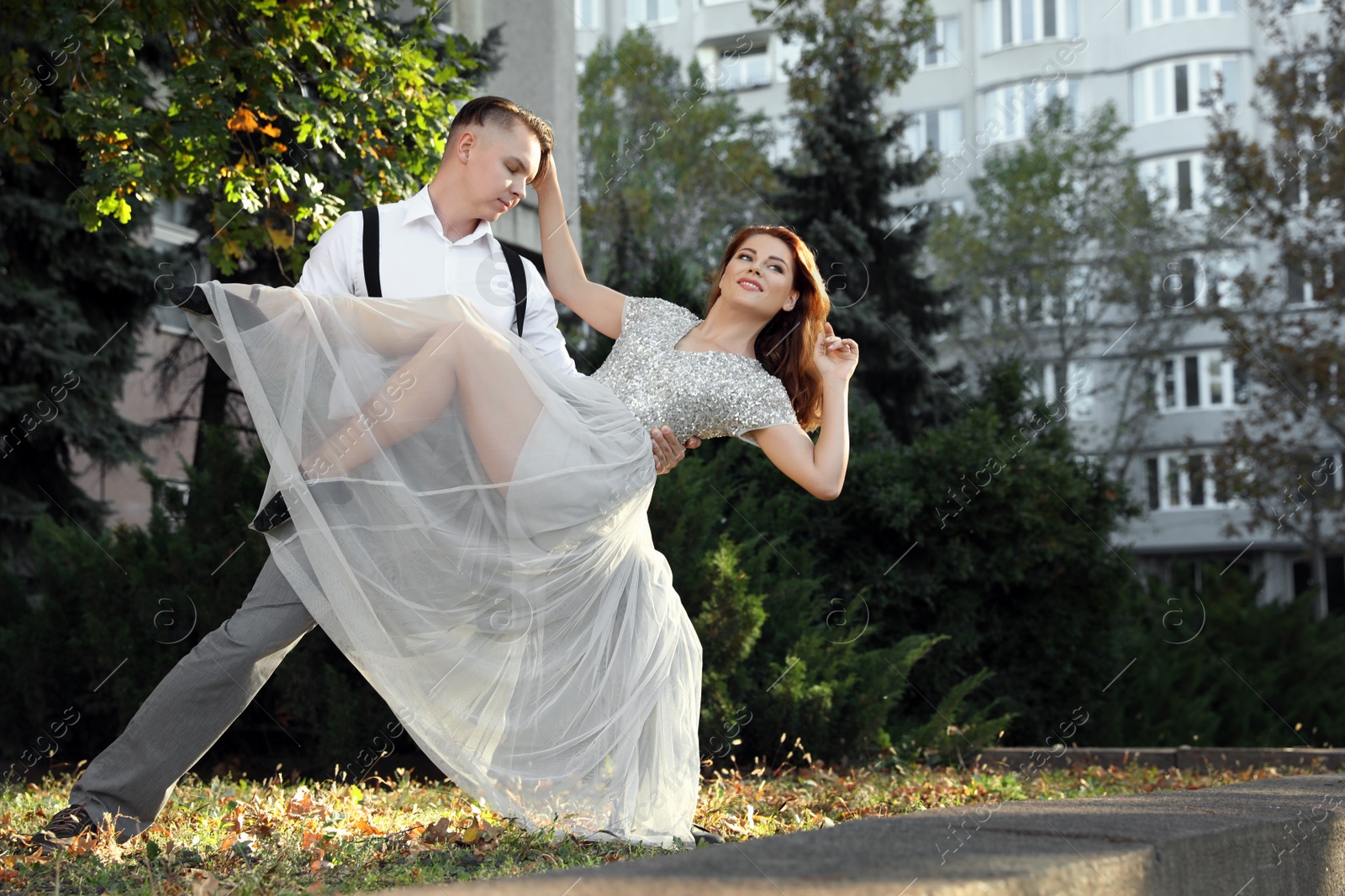 Photo of Beautiful young couple practicing dance moves outdoors