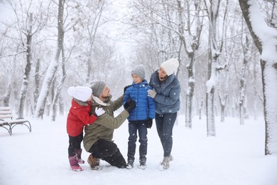 Family spending time outside on winter day. Christmas vacation