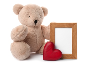 Photo of Cute teddy bear with red heart and frame on white background. Valentine's day celebration