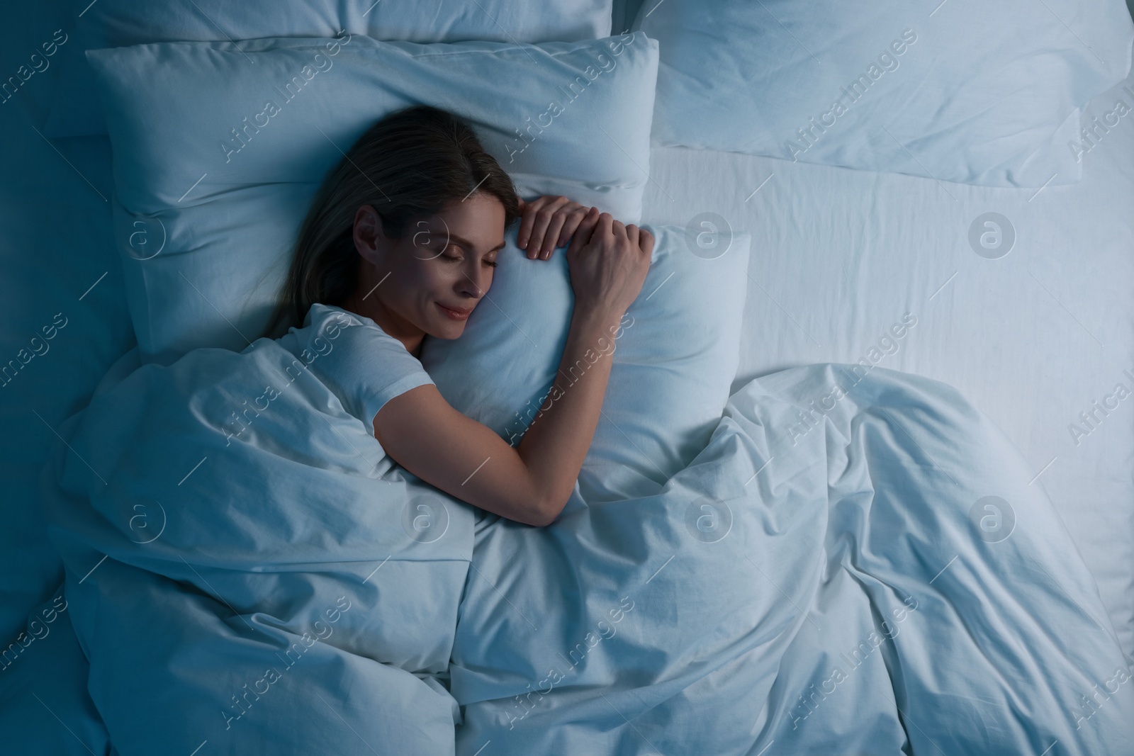 Photo of Woman sleeping in bed at night, above view. Space for text