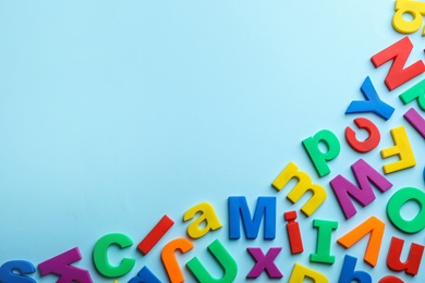Photo of Plastic magnetic letters on color background, top view with space for text