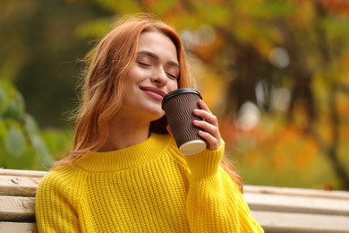 Photo of Portrait of beautiful woman with paper cup enjoying autumn outdoors