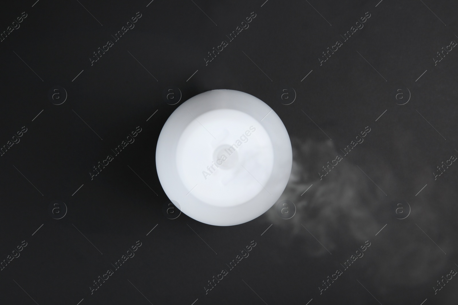 Photo of Modern aroma humidifier on black background, top view