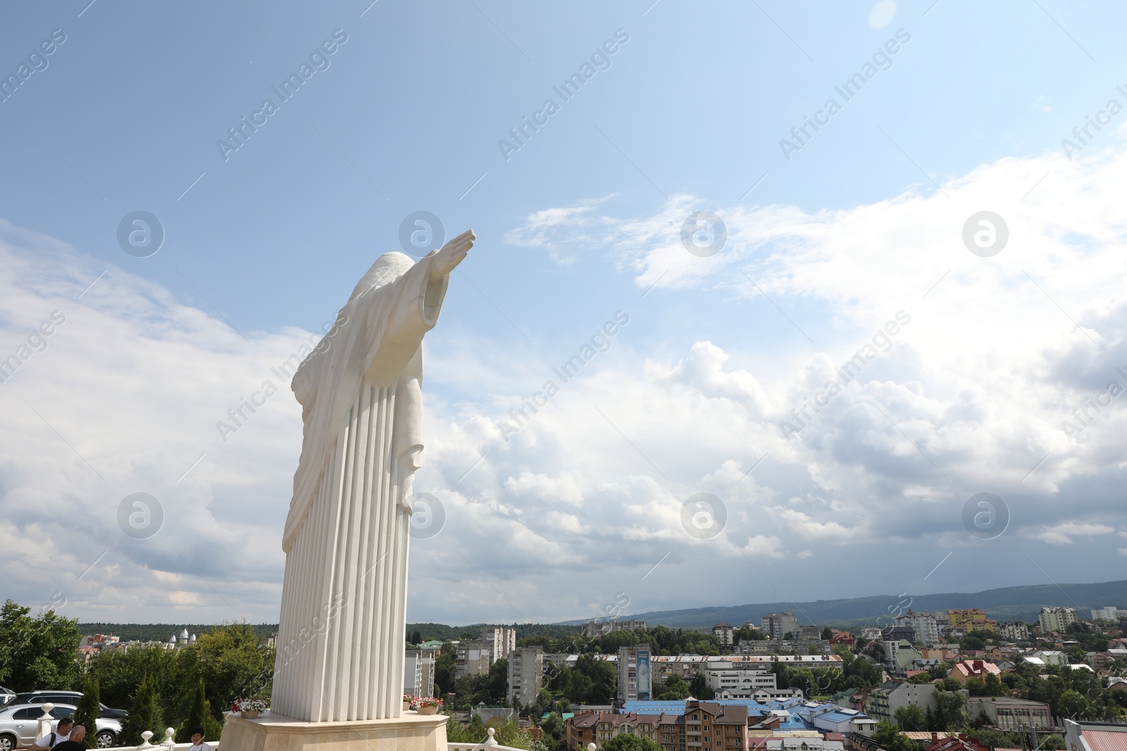 Photo of Truskavets, Ukraine - July 22, 2023: Statue of Christ the Redeemer against beautiful cityscape