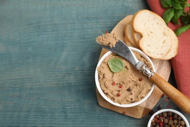Photo of Delicious meat pate with spices, fresh bread and knife on blue wooden table, flat lay. Space for text