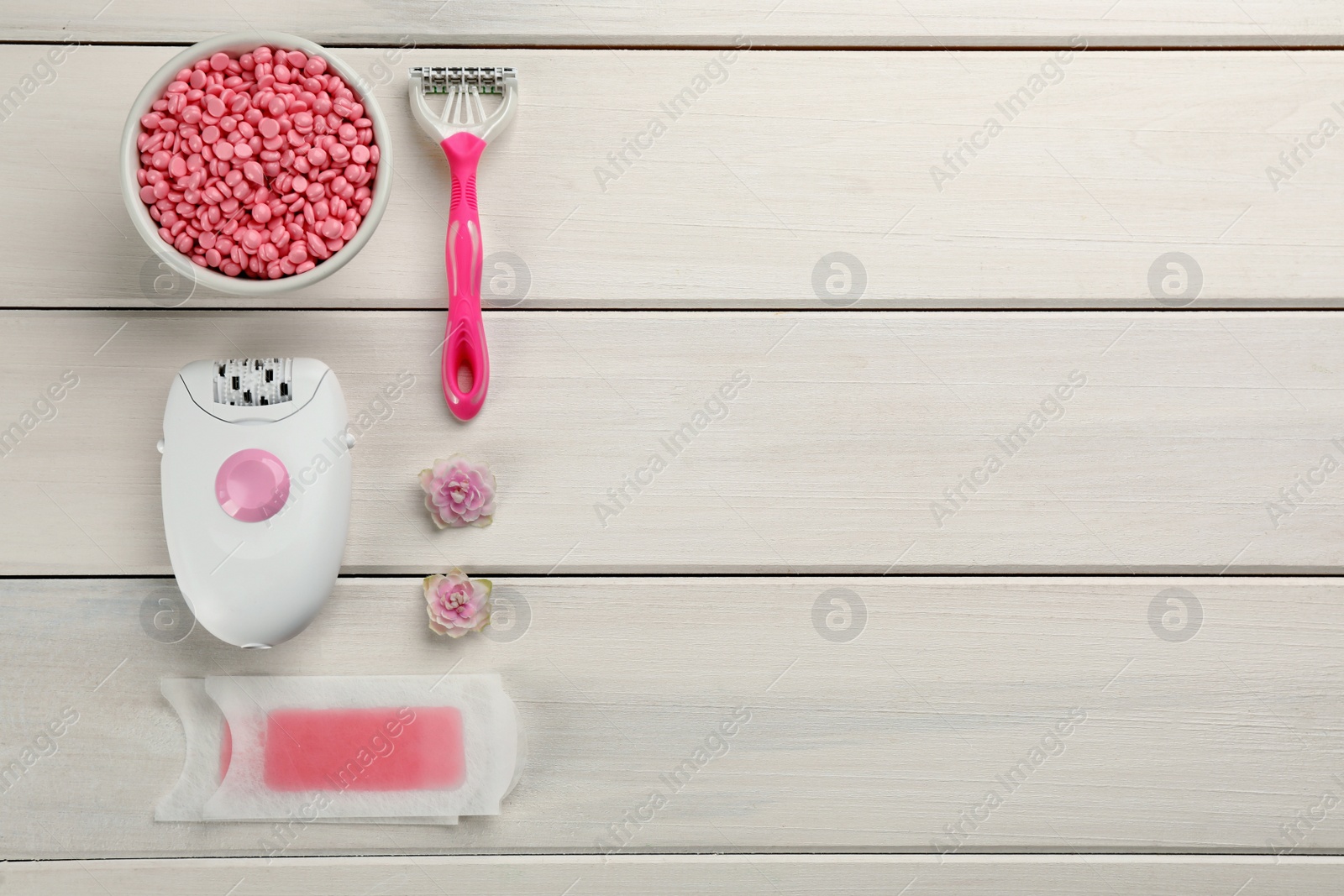 Photo of Set of epilation products on white wooden table, flat lay. Space for text