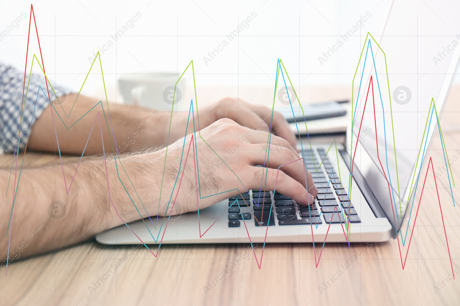 Image of Finance trading concept. Man working with laptop at table and chart, closeup